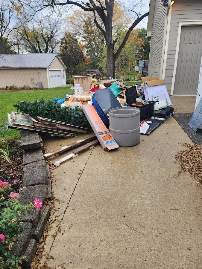Dumpster being loaded with debris for 12 Yard Dumpster Rental in Stoughton